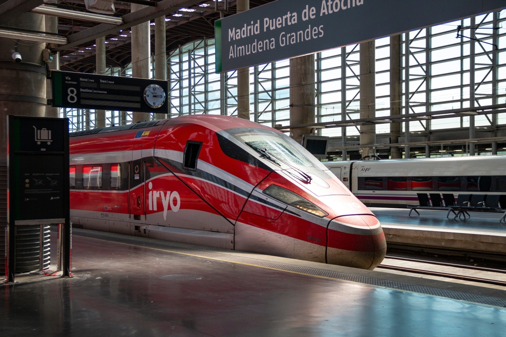 An iryo high-speed train at the platform at Madrid Puerta de Atocha station